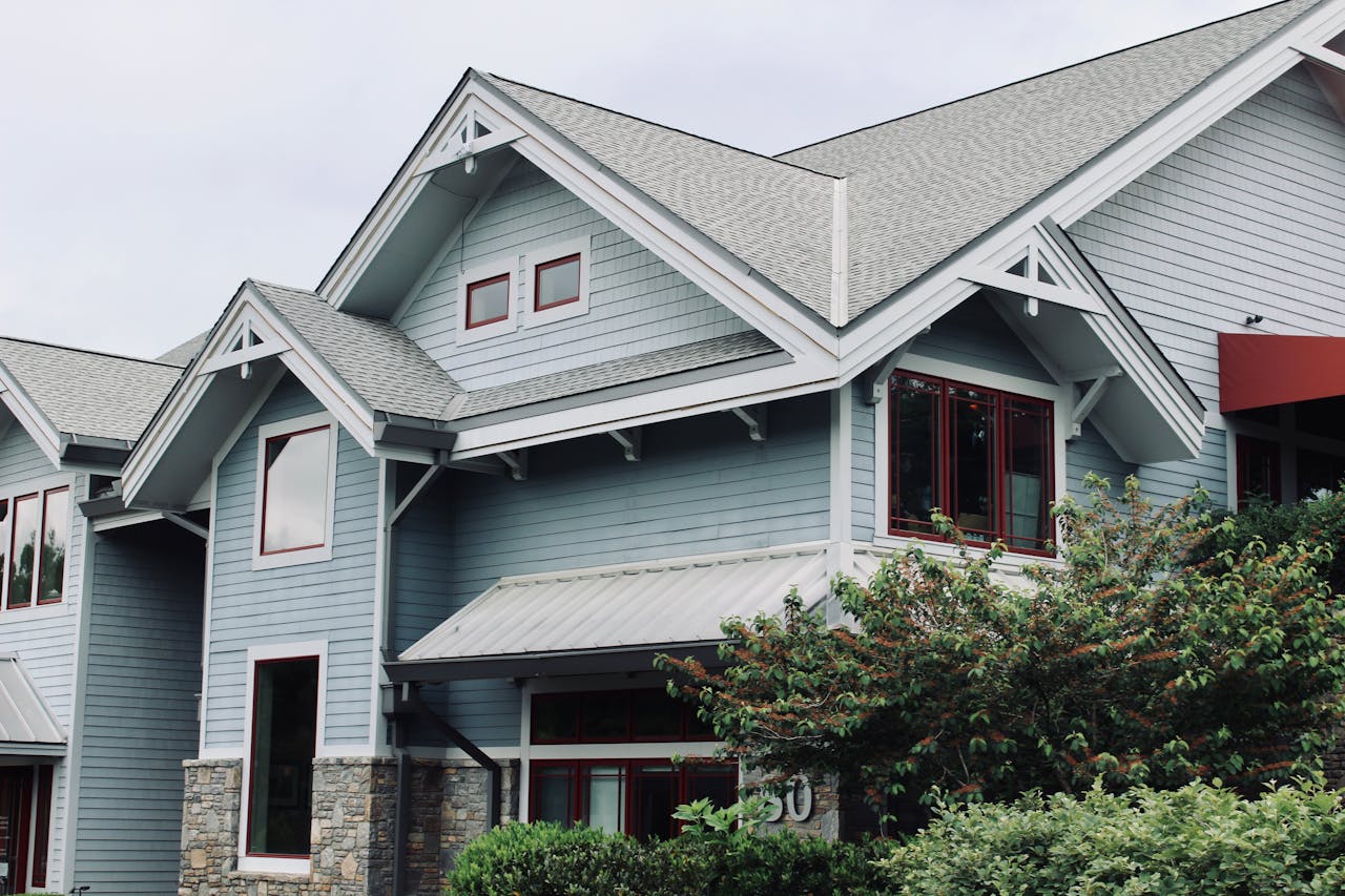 Home Charming blue house exterior with modern architectural features in Asheville, NC.