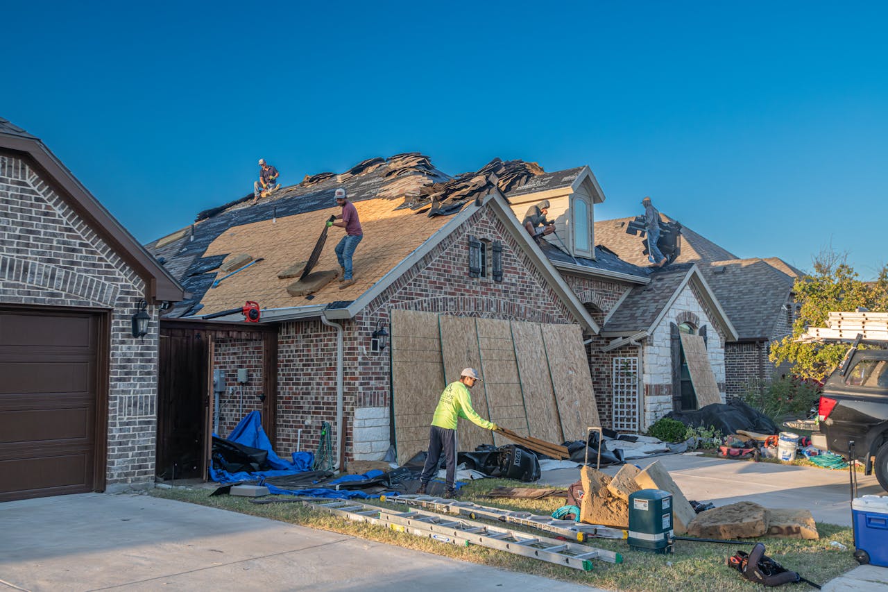 About Workers engage in roof replacement on a brick house in Fort Worth, Texas.